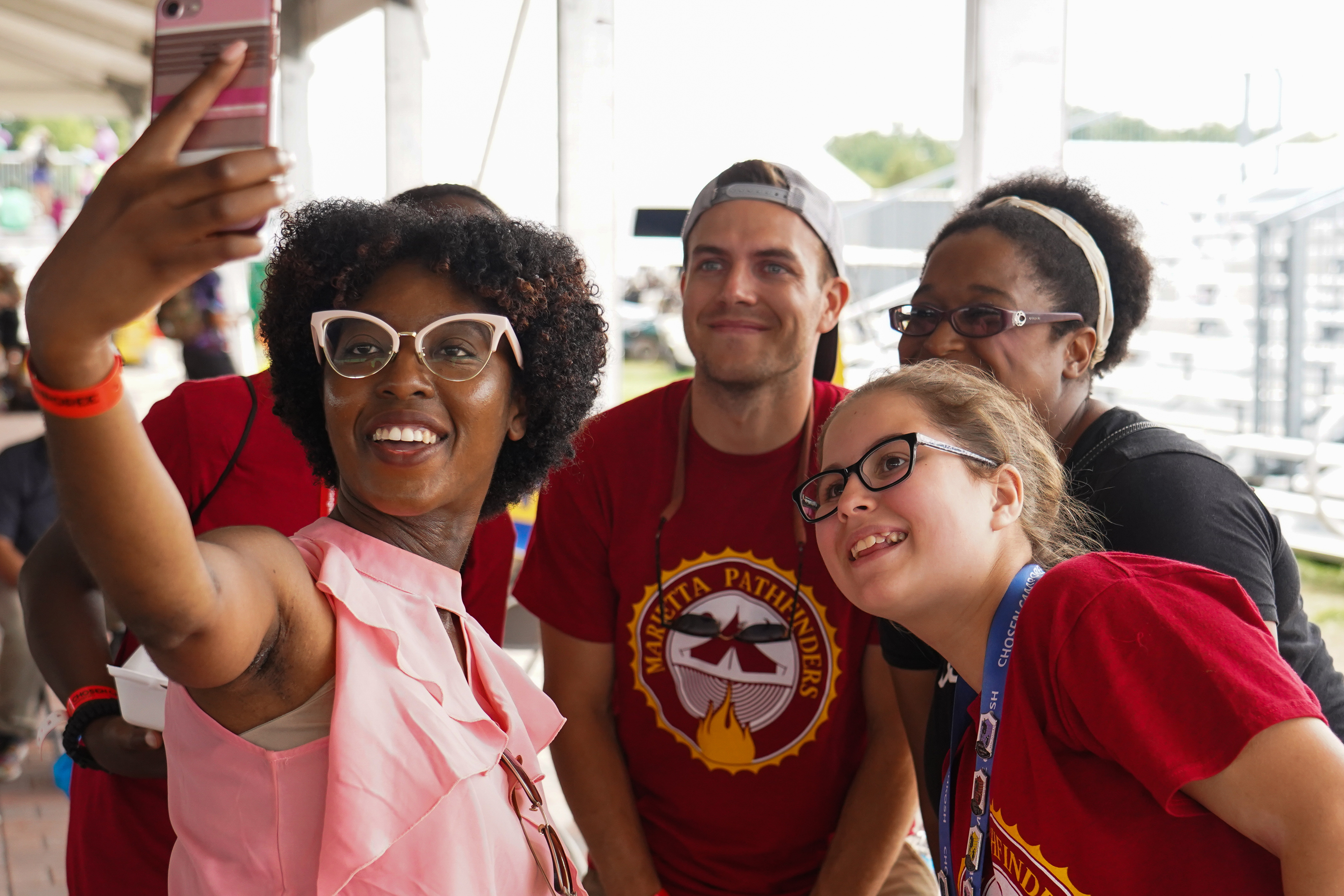 Darnisha Thomas, who pastors in the Minnesota Conference, takes a selfie with a group of Pathfinders for a selfie at the NextGen Ice Cream Social on August 17.  