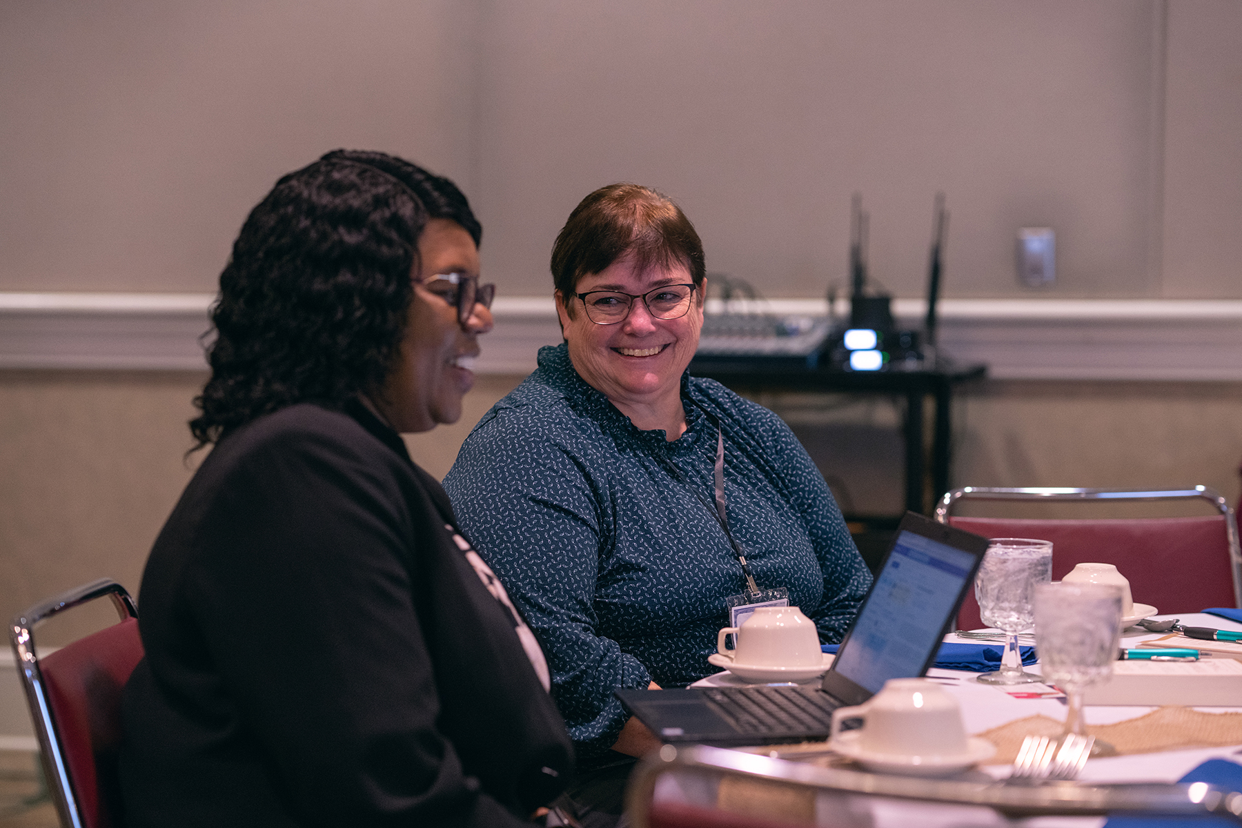 Two ladies speaking at their table during the Adventist Women Leaders (AWL) luncheon held January 11, 2023, at the conclusion of the North American Division 2023 “Replenish” Adventist Ministries Convention