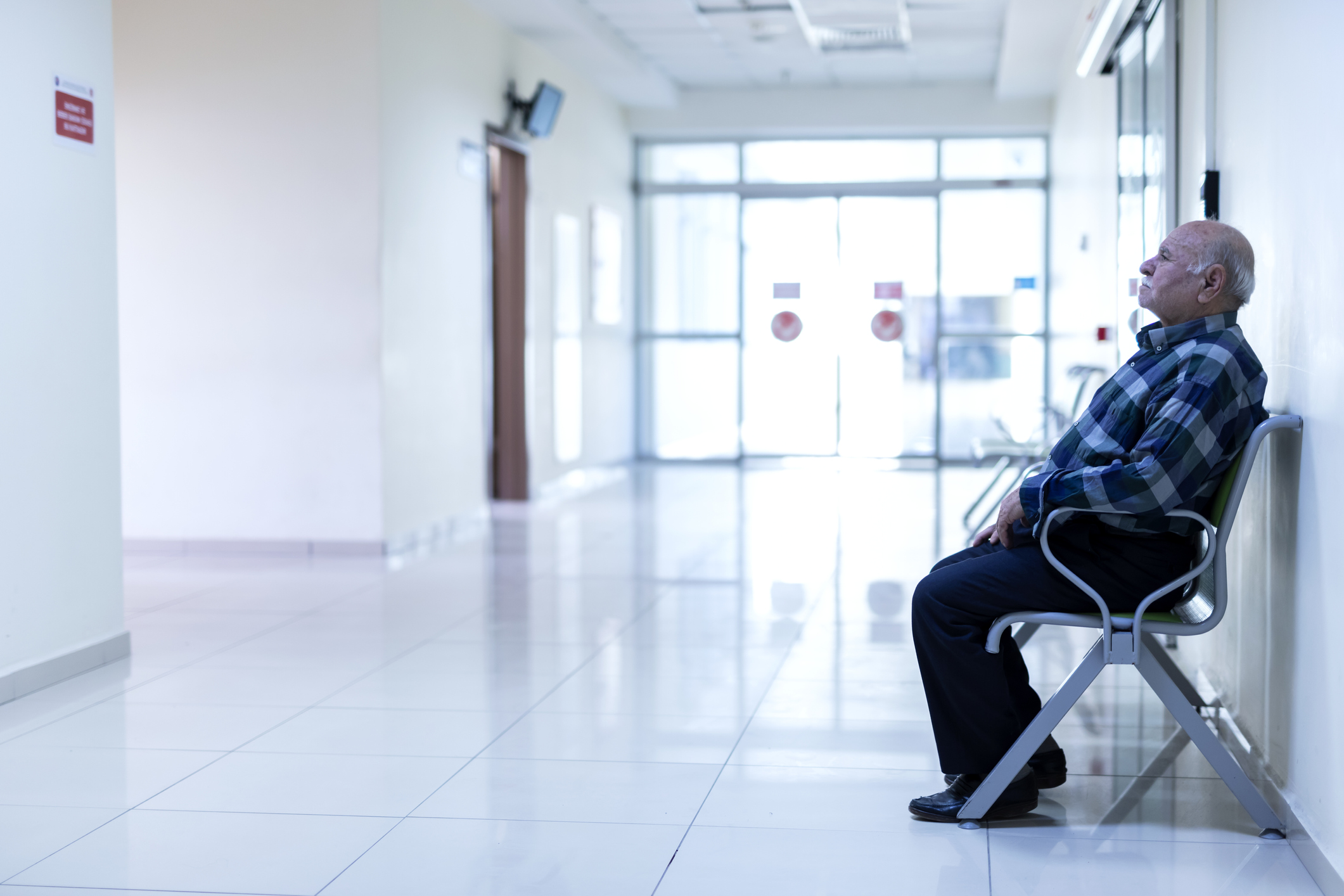 stock photo of older man in hospital waiting area