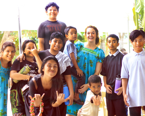 Madeline Cadavero, student missionary (through the North American Division Office of Volunteer Ministries) poses with some of her students in Chuuk, Micronesia.