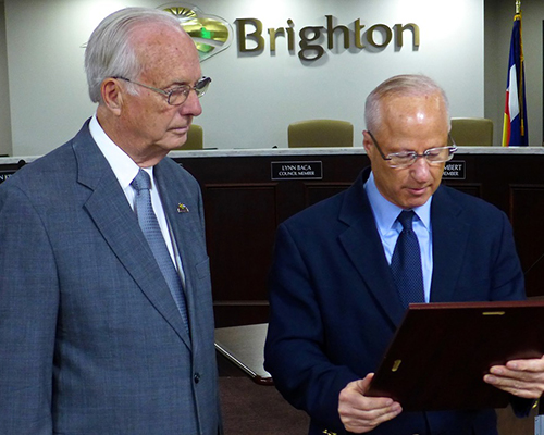 U.S. Representative Mike Coffman (right) presents Pastor Rex Bell with Congressional Citation, Brighton, May 1, 2018