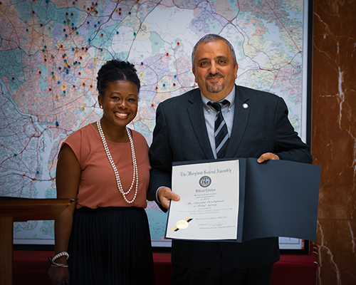 State assemblywoman Jheanelle Wilkins presents Imad Madanat, vice president for programs at ADRA International, with an official citation for ADRA’s refugee work from the state of Maryland.