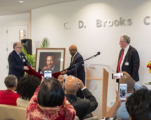 Dan Jackson, NAD president, Alex Bryant, NAD executive secretary, and Ken Denslow, executive assistant to the president of NAD, unveil a portrait during the C.D. Brooks Prayer Chapel Dedication Ceremony. 