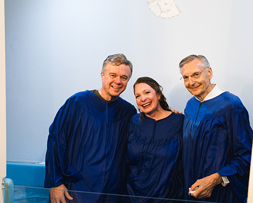 Hayes and Paige Parnell (left – center) smile alongside Pastor Edward Skoretz (right) after their baptism at Summerville Seventh-day Adventist Church in Summerville, Georgia. 