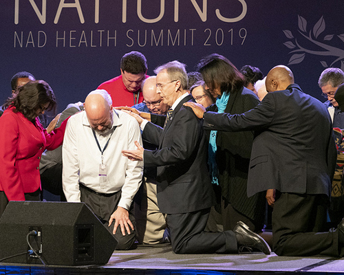 Derek Morris, president of Hope Channel International, overs special prayer.