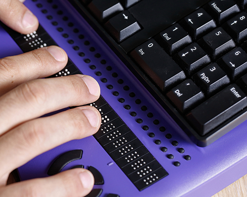 person using braille computer keyboard