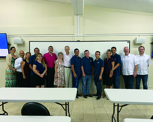 Personnel from Southern Adventist University and the Cuba Adventist Theological Seminary pose for a photo in the former storage room turned into a virtual classroom.