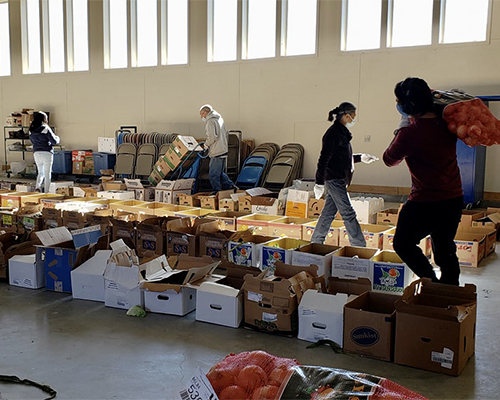 Staff of La Vida Mission sort and box produce ahead of providing relief distribution in Farmington, New Mexico