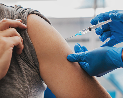 stock photo of man getting vaccine in arm