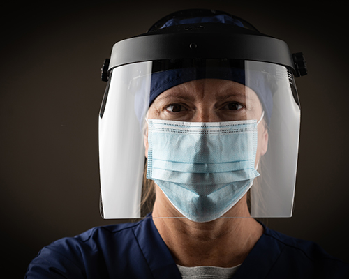 stock photo of medical worker with face mask and shield