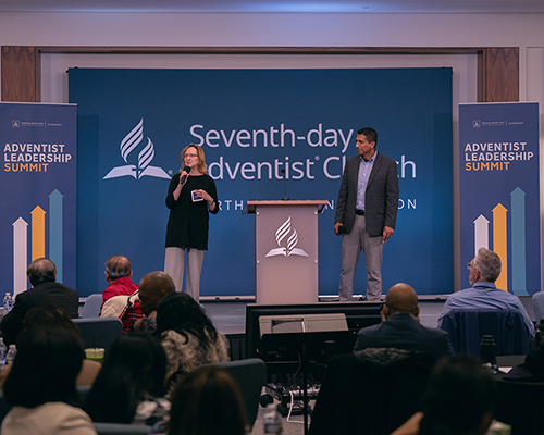 2023 NAD leadership summit hosts Debbie Rivera and John Rengifo address those gathered on Nov. 12.