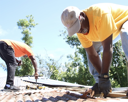 ACS volunteers help repair a roof on a house in Guam in fall 2023