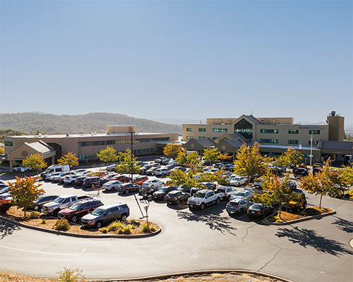 Photo of Pacific Union College building and its parking lot on a sunny day