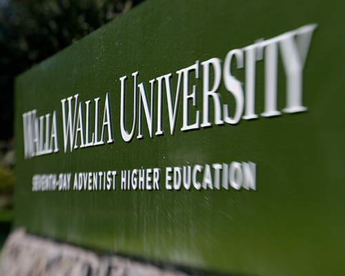 Close-up of green sign reading "Walla Walla University: Seventh-day Adventist Higher Education"