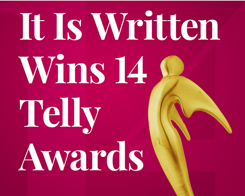 Gold statue on pink background with text reading "It Is Written Wins 14 Telly Awards"