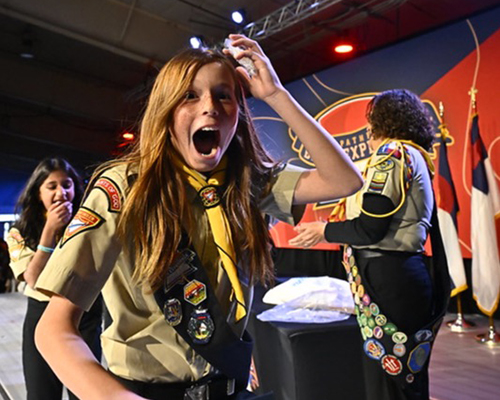 Young girl in pathfinder uniform making a shocked facial expression towards the camera
