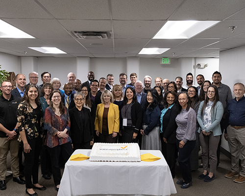 Voice of Prophecy team and guests celebrate 95th birthday of the ministry, pose with cake