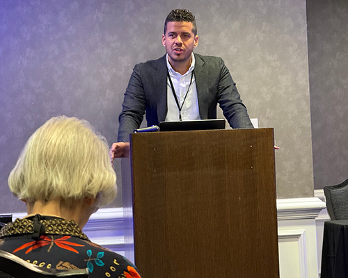 Hispanic man stands at a podium speaking