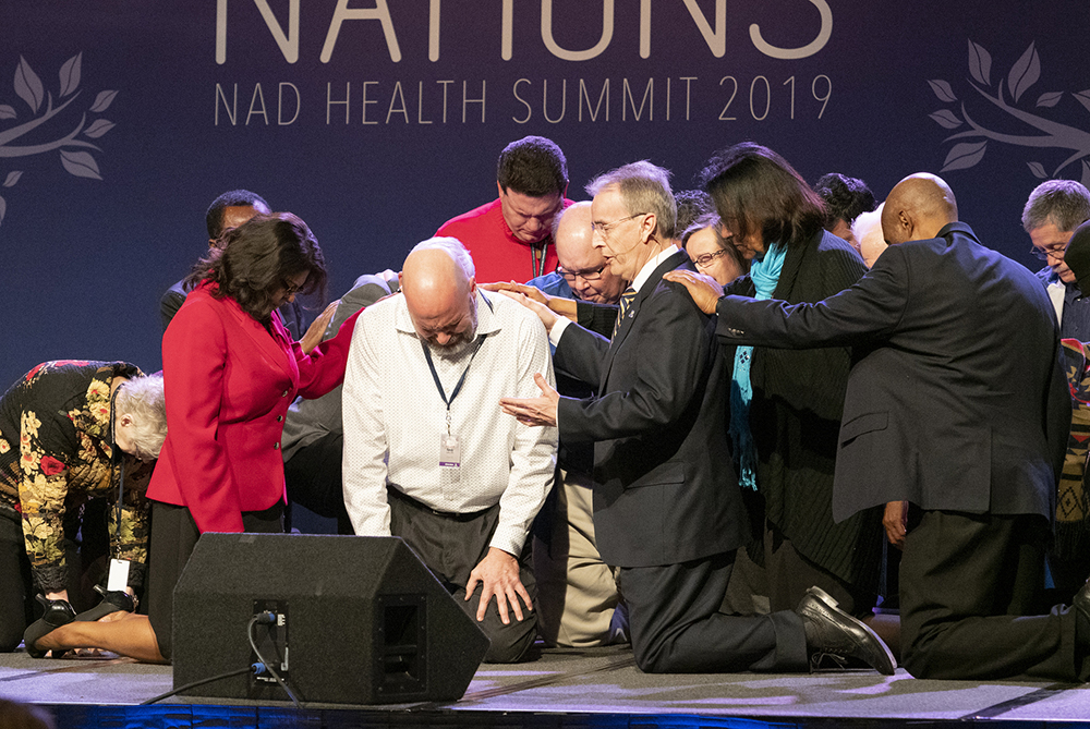 Derek Morris, featured speaker of the NAD Health Summit and president of Hope Channel International, offers special prayer. Photo: Dan Weber
