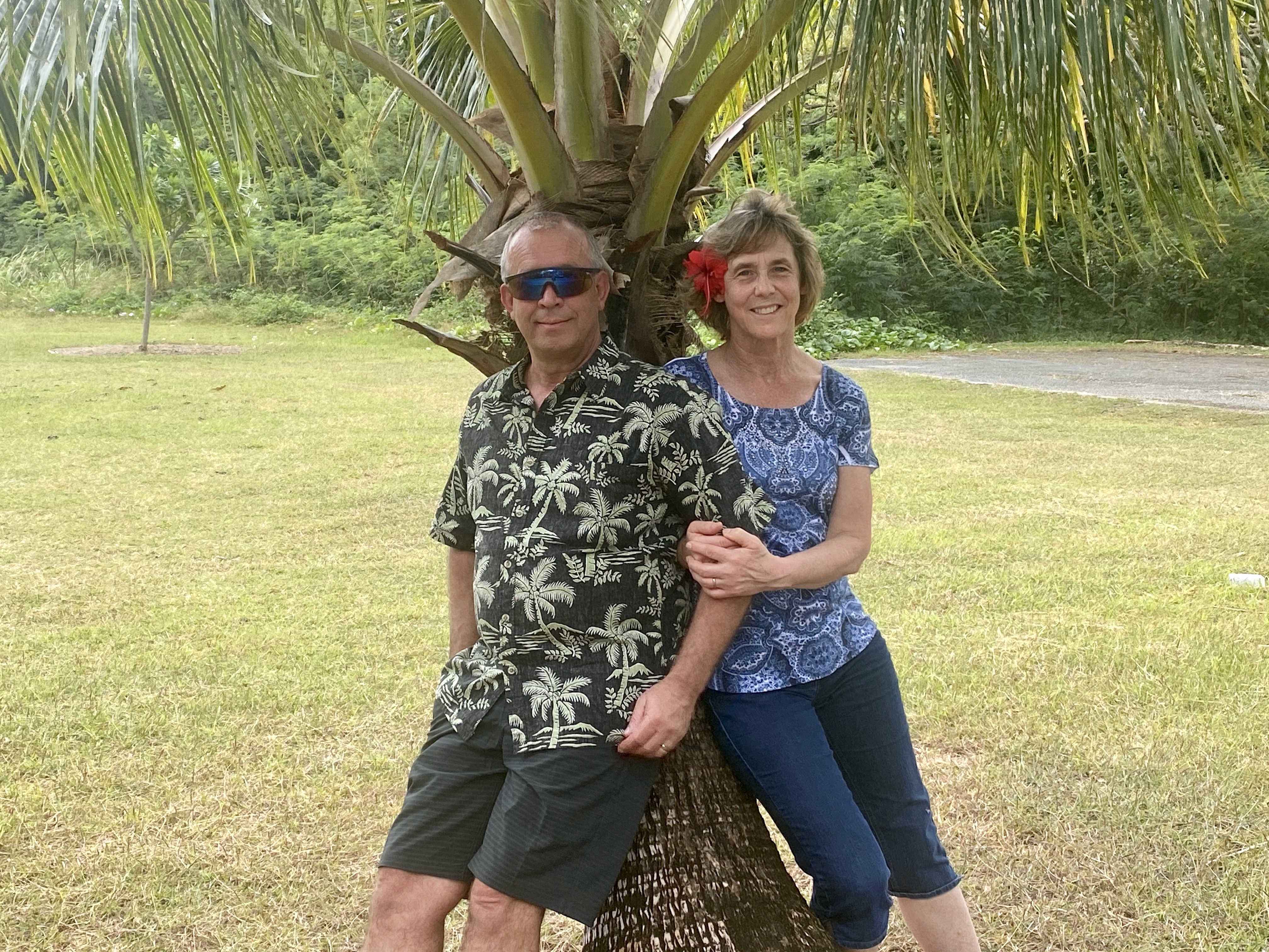 Arne and Teen Nielsen (older caucasian couple posed by palm tree