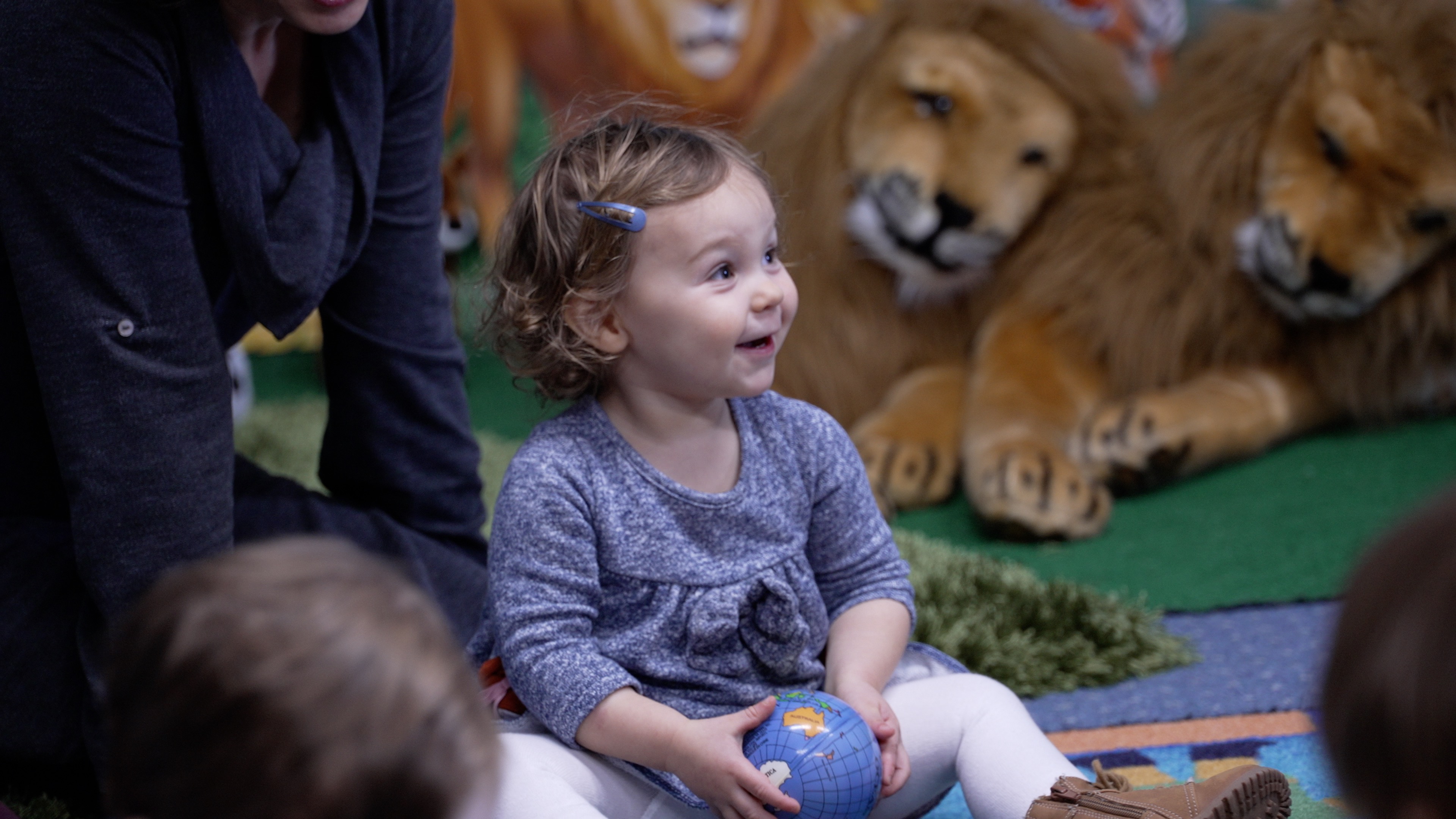 Toddler girl smiles during Sabbath School