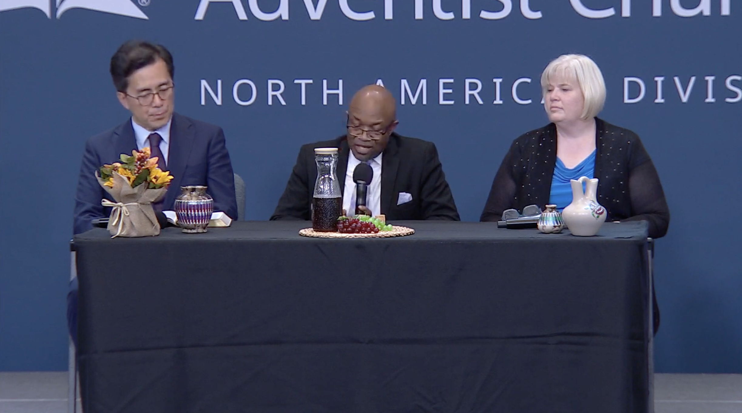 Three NAD officers, Kyoshin Ahn, G. Alexander Bryant, and Judy Glass present communion service