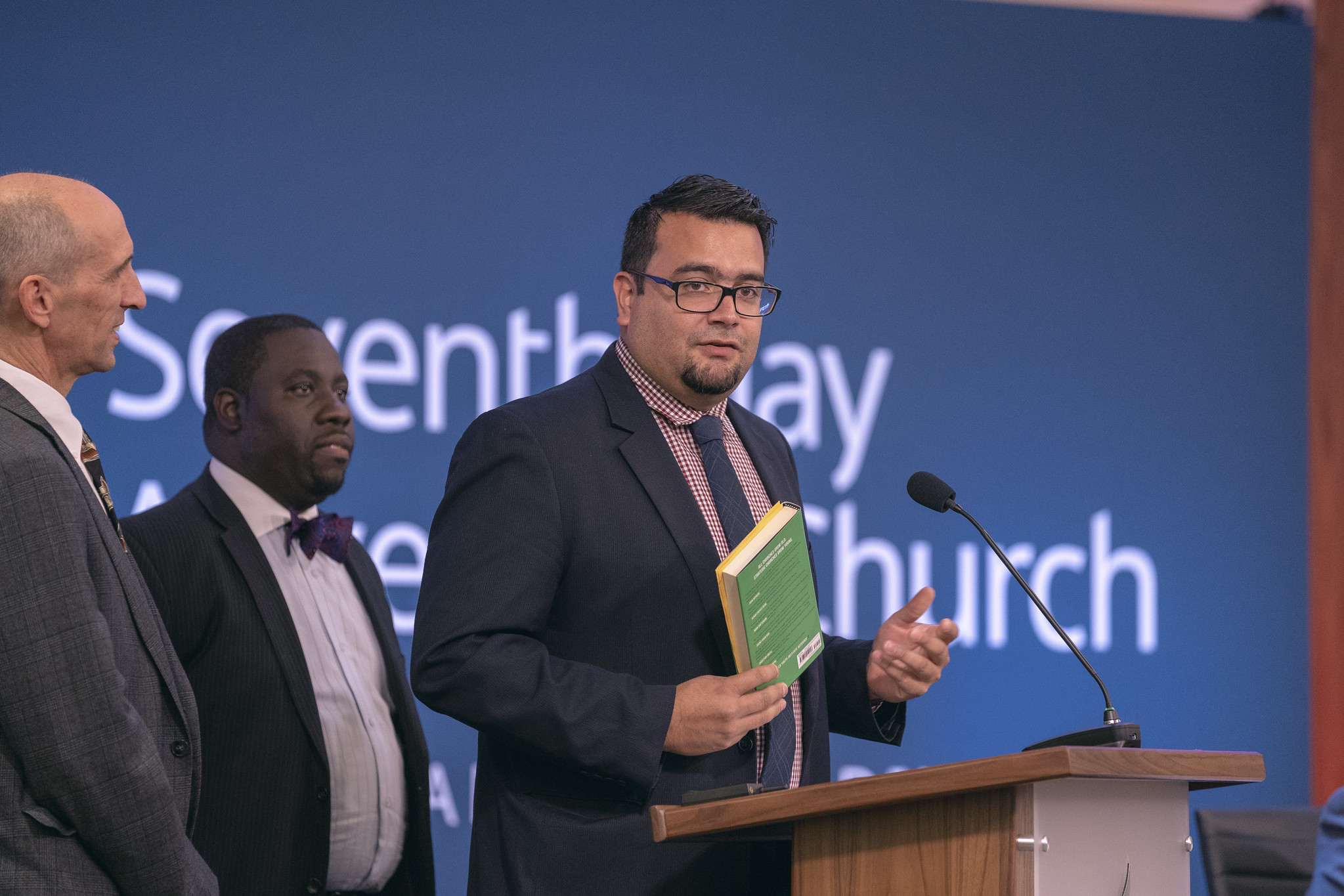 Armando Miranda, Youth and Young Adult Ministries associate director, highlights materials for young adults and ministry, including the Growing Young resource book. Photo by Dan Weber