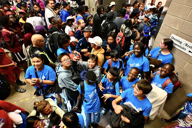 Pathfinders and staff crowd into the backstage area of the Heritage Theater, one of several buildings that was opened to house evacuees during a thunderstorm on Tuesday afternoon, August 6, 2024, at the Believe the Promise International Pathfinder Camporee in Gillette, Wyoming. Photo: Cerron Pollard, North American Division