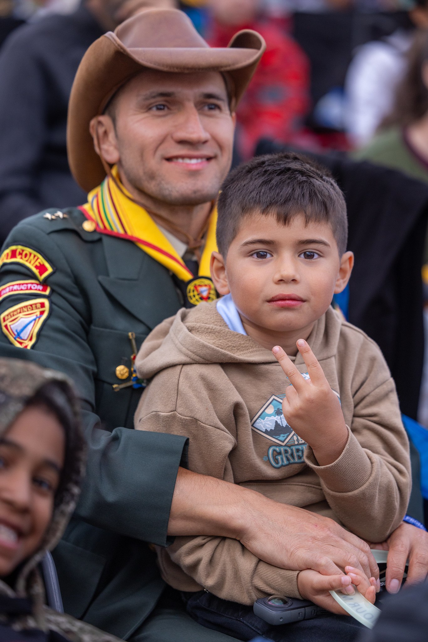 For many parents, the International Pathfinder Camporee is a chance to pass on a legacy of Pathfindering and faith to their children. Here a father-son duo take in the final program on Friday, August 9, 2024. Photo by Alvin Goulbourne/North American Division