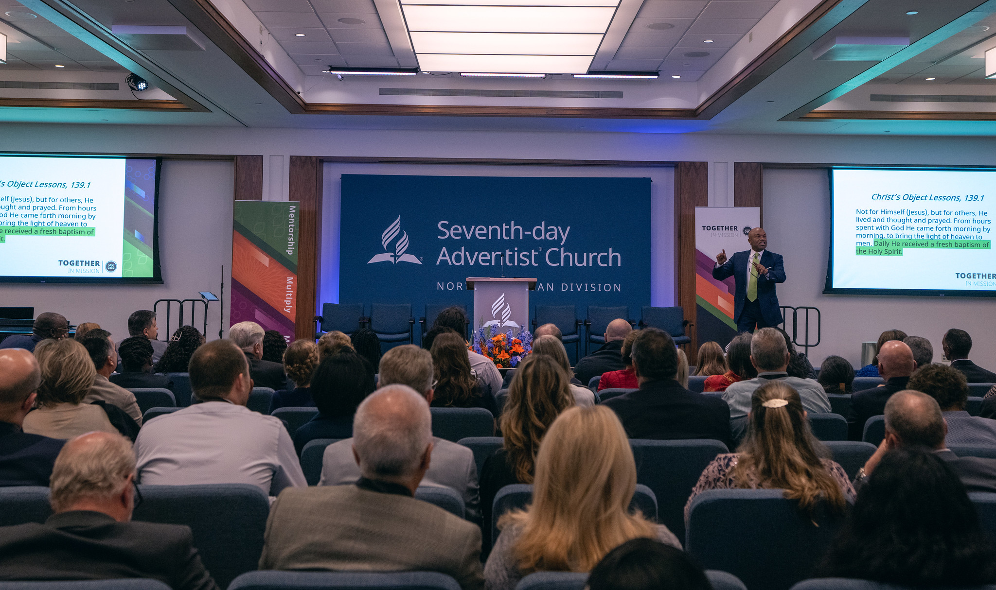 NAD YEM 2024 headquarters auditorium with attendees and preacher