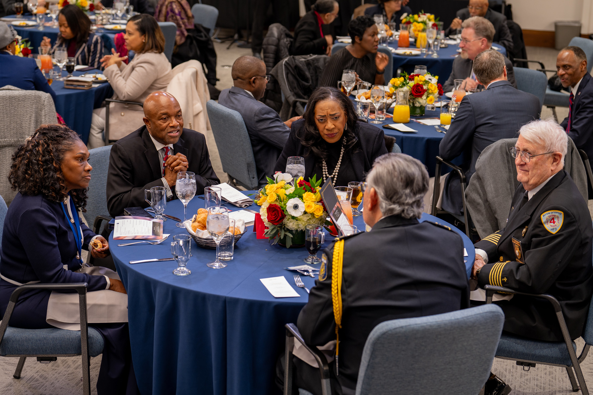 Tables of people enjoy meals, conversation and prayer at the prayer breakfast