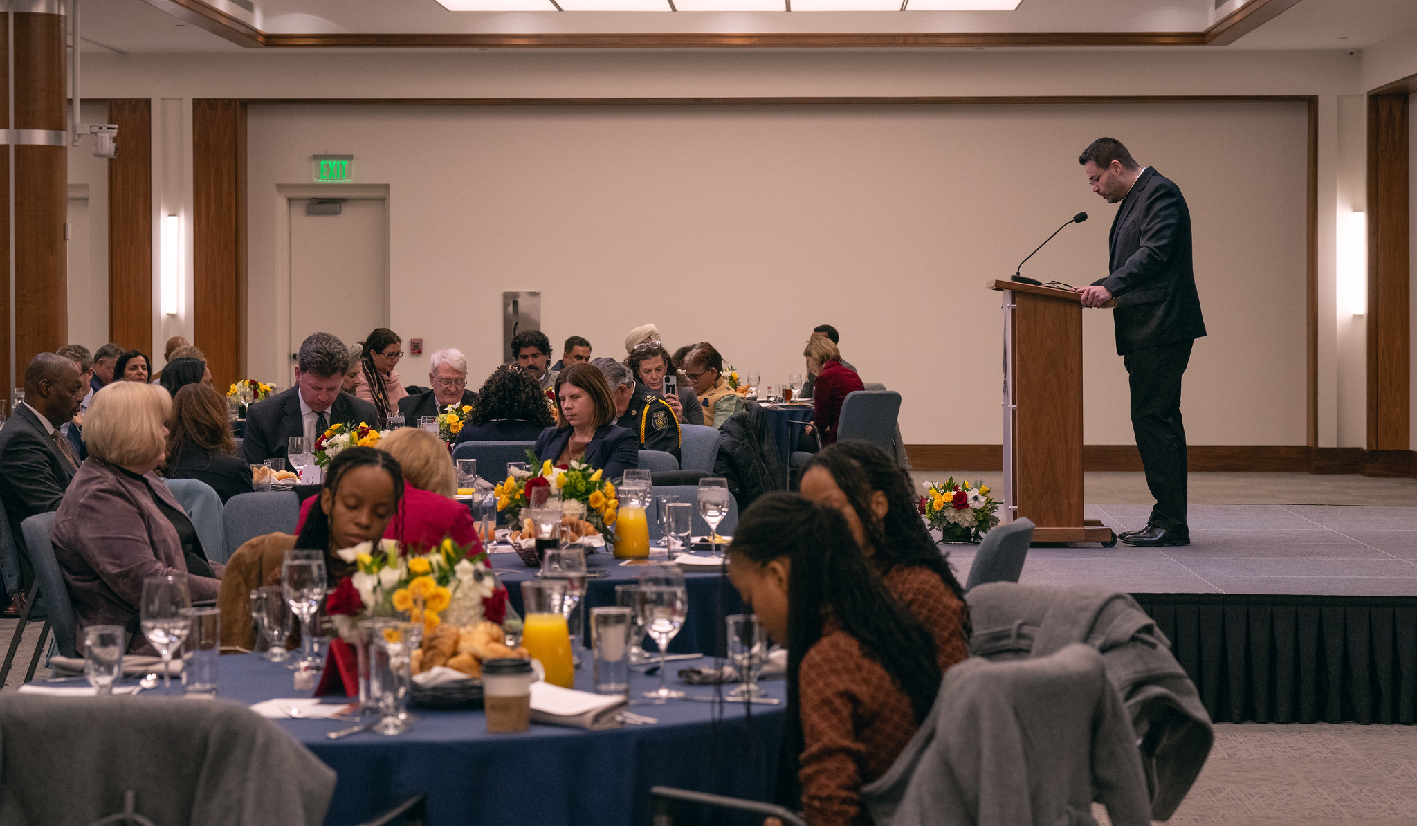 Prayer breakfast attendees bow their heads during one of several prayers