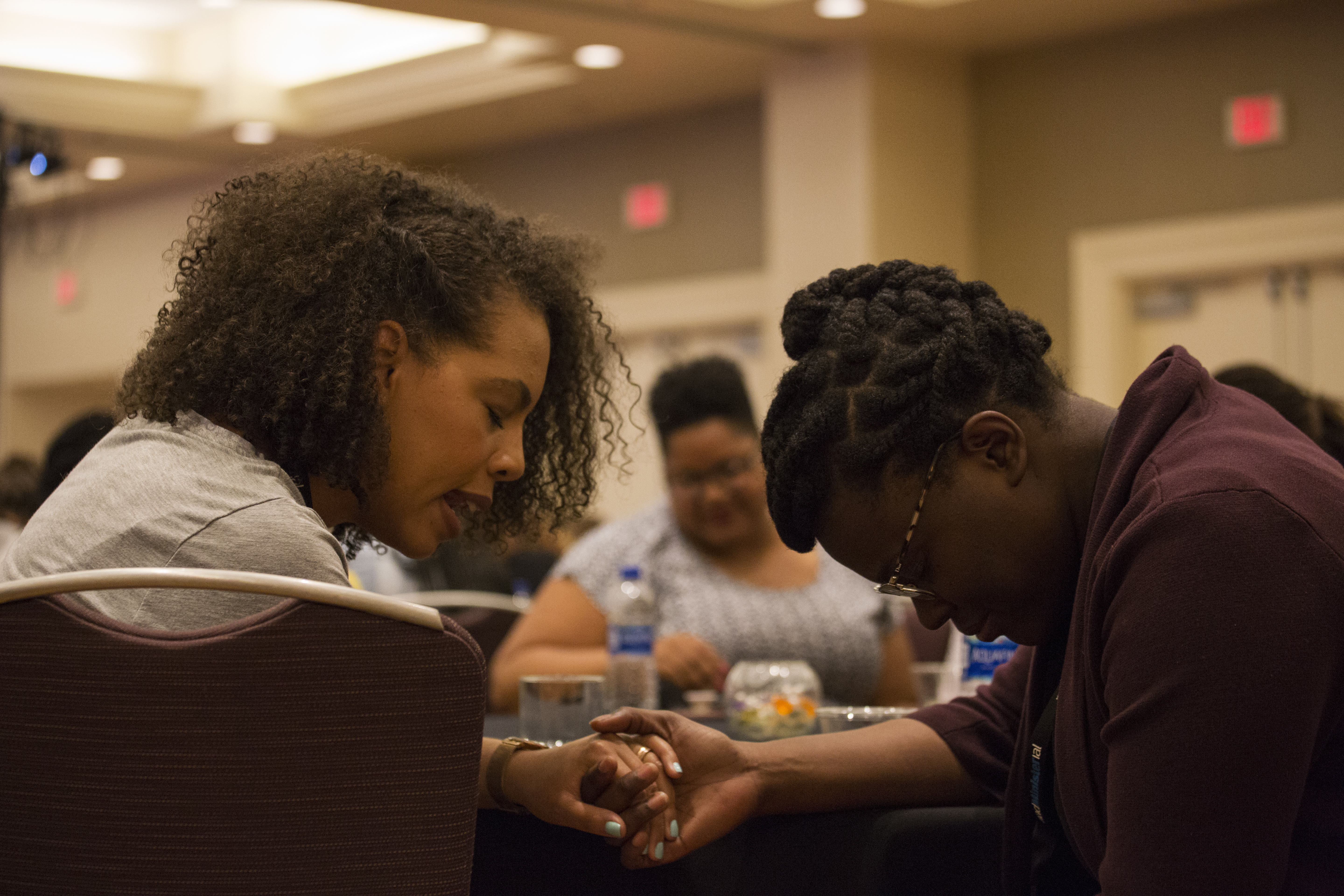 Two women clergy pray for each other during a general session of the 2018 NAD Women Clergy Retreat in Indian Hills, California.