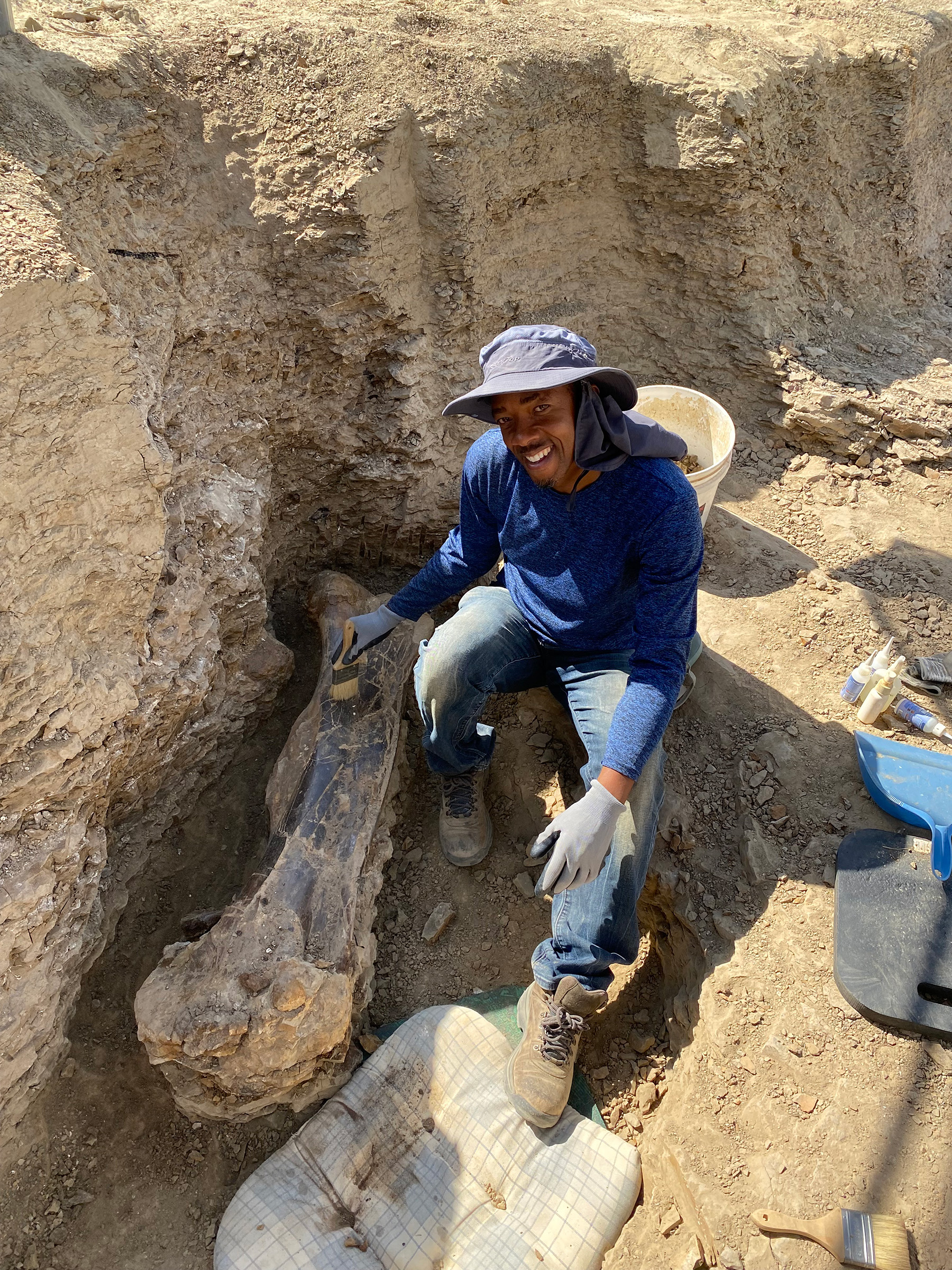 Smiling Black man at an excavation site