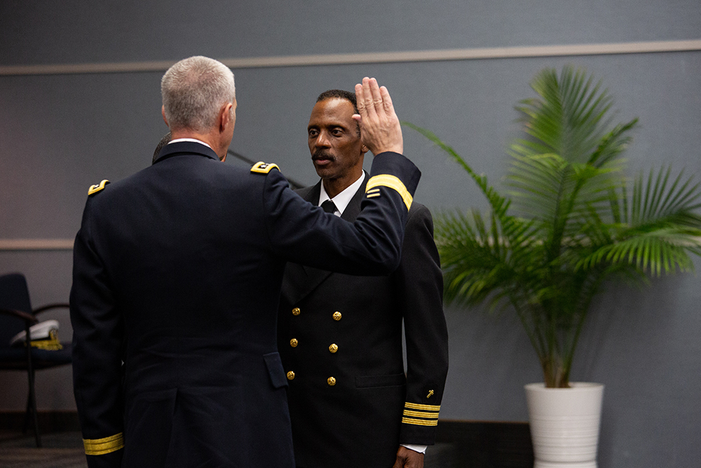Lt. General Reynold Hoover presents Washington Johnson, II with the oath of office as part of the promotion ceremony.