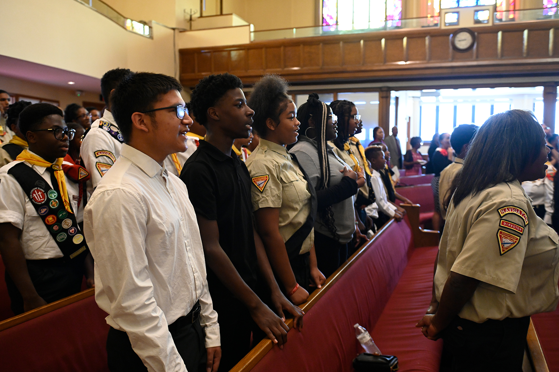 photo of Pathfinders standing in the pews at a church