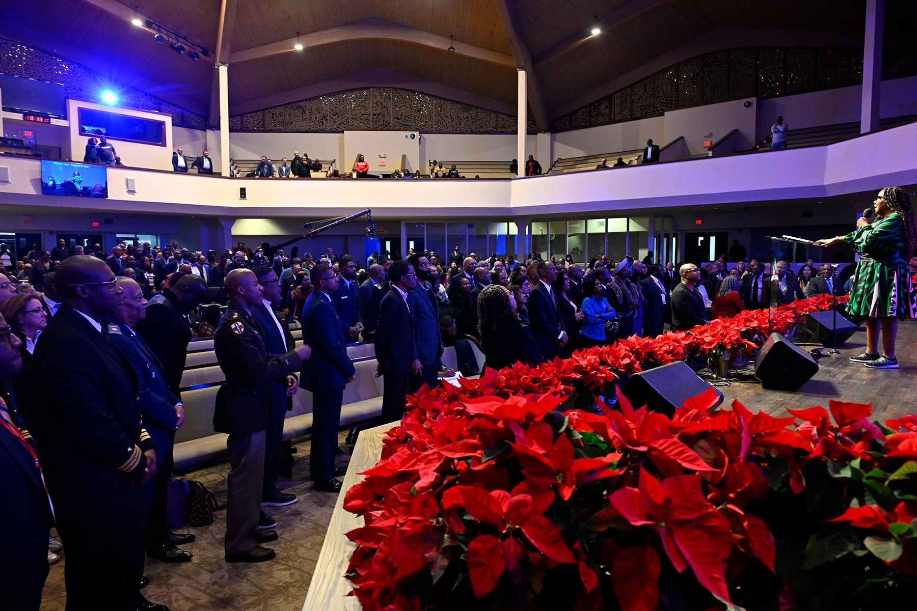 A black woman speaks to a packed sanctuary