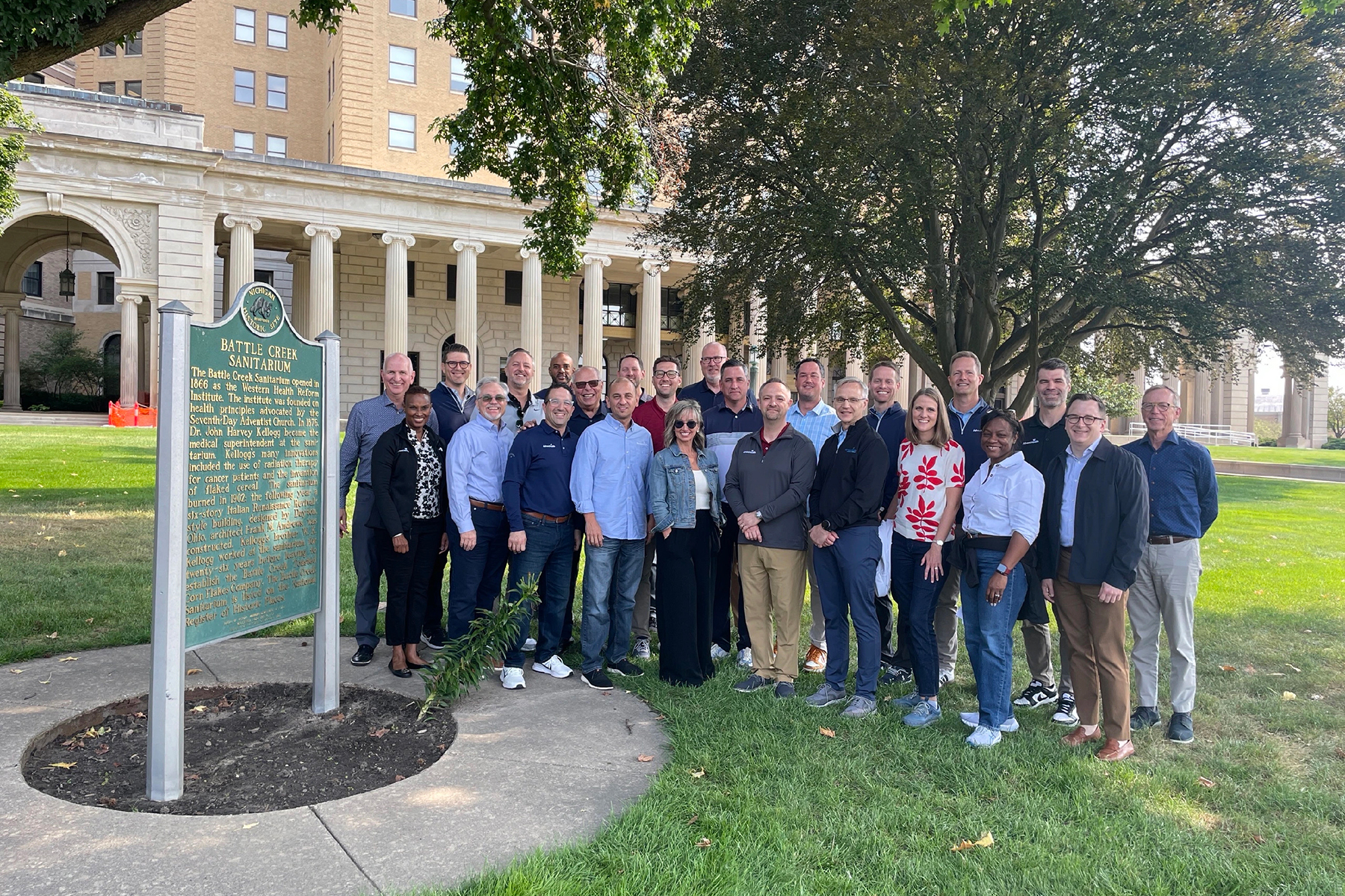 Group of men and women standing outside of the Battle Creek Sanitarium