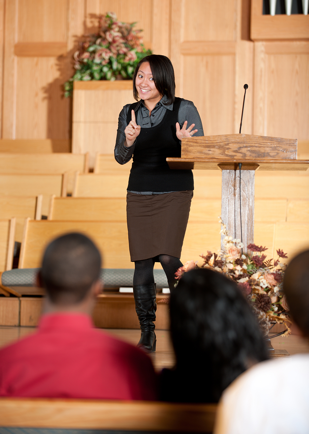 Young Asian woman preaching on pulpit at church