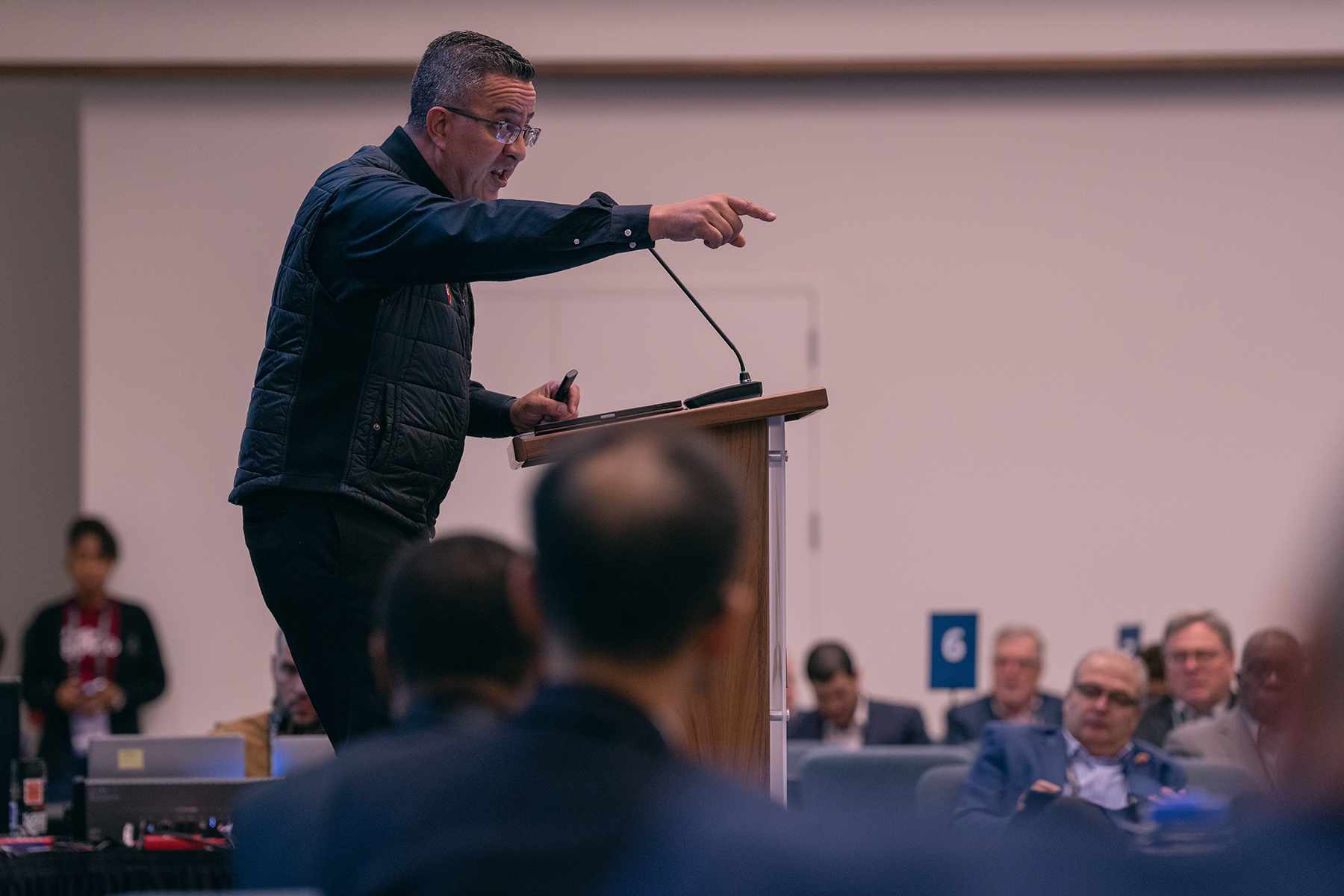 A man speaks in front of a crowd