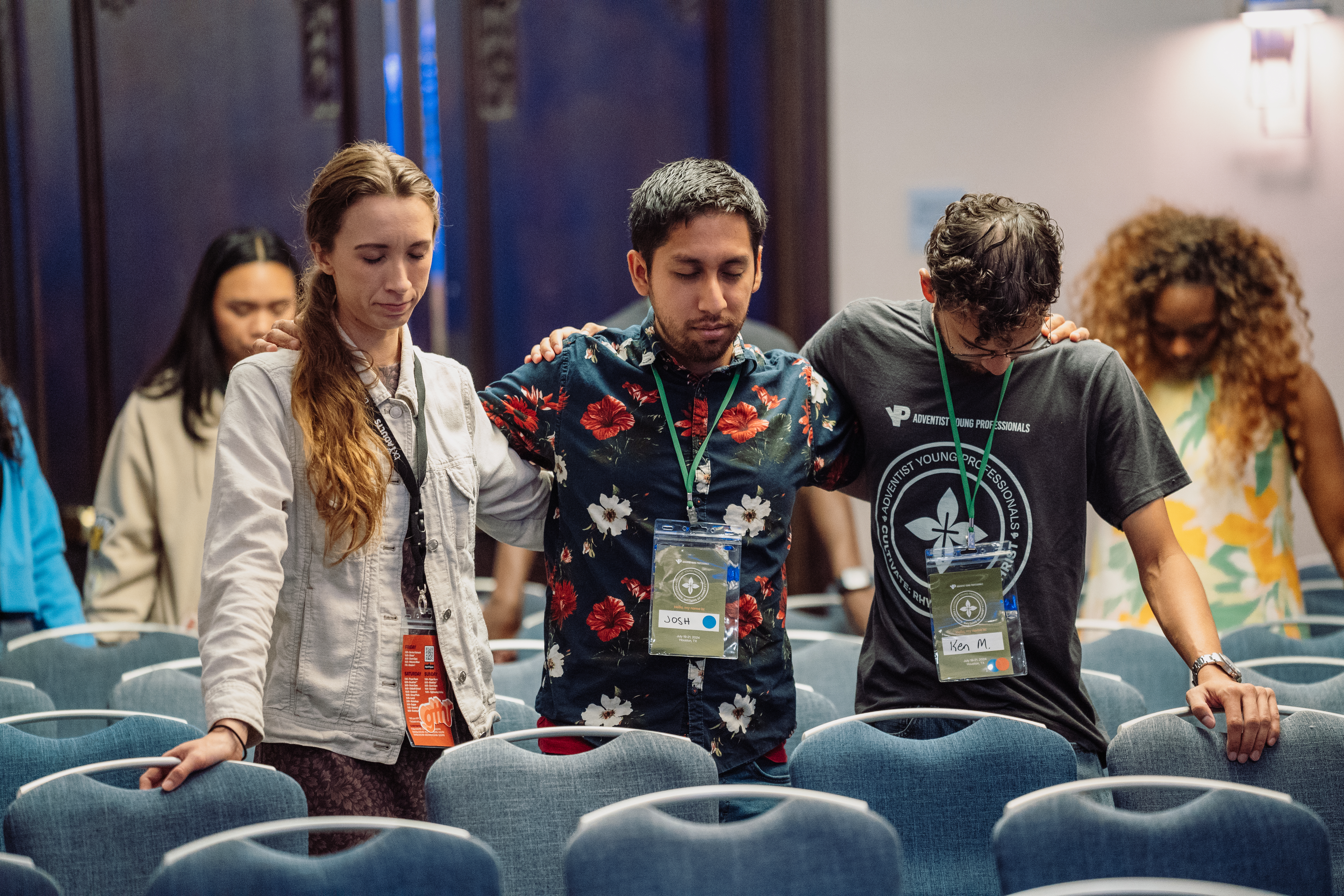 AYP conference attendees bow their heads in prayer at the 2024 convention