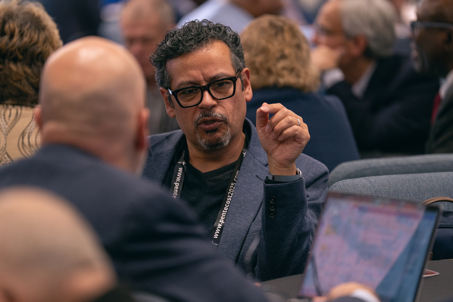 Two men in deep discussion at a conference.