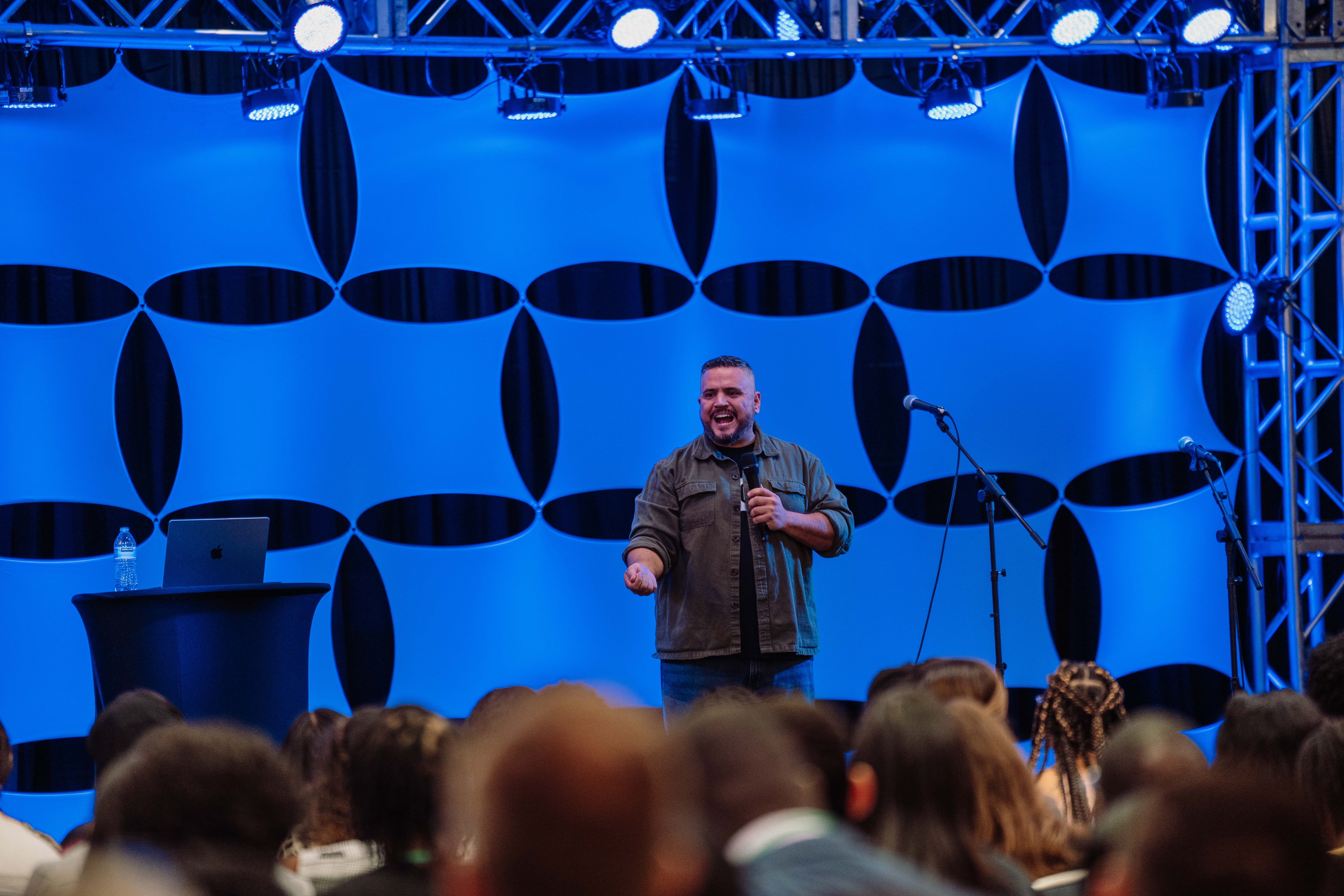 Photo by Sebastian Suarez at the AYP convention, male young adult speaker in front of general session