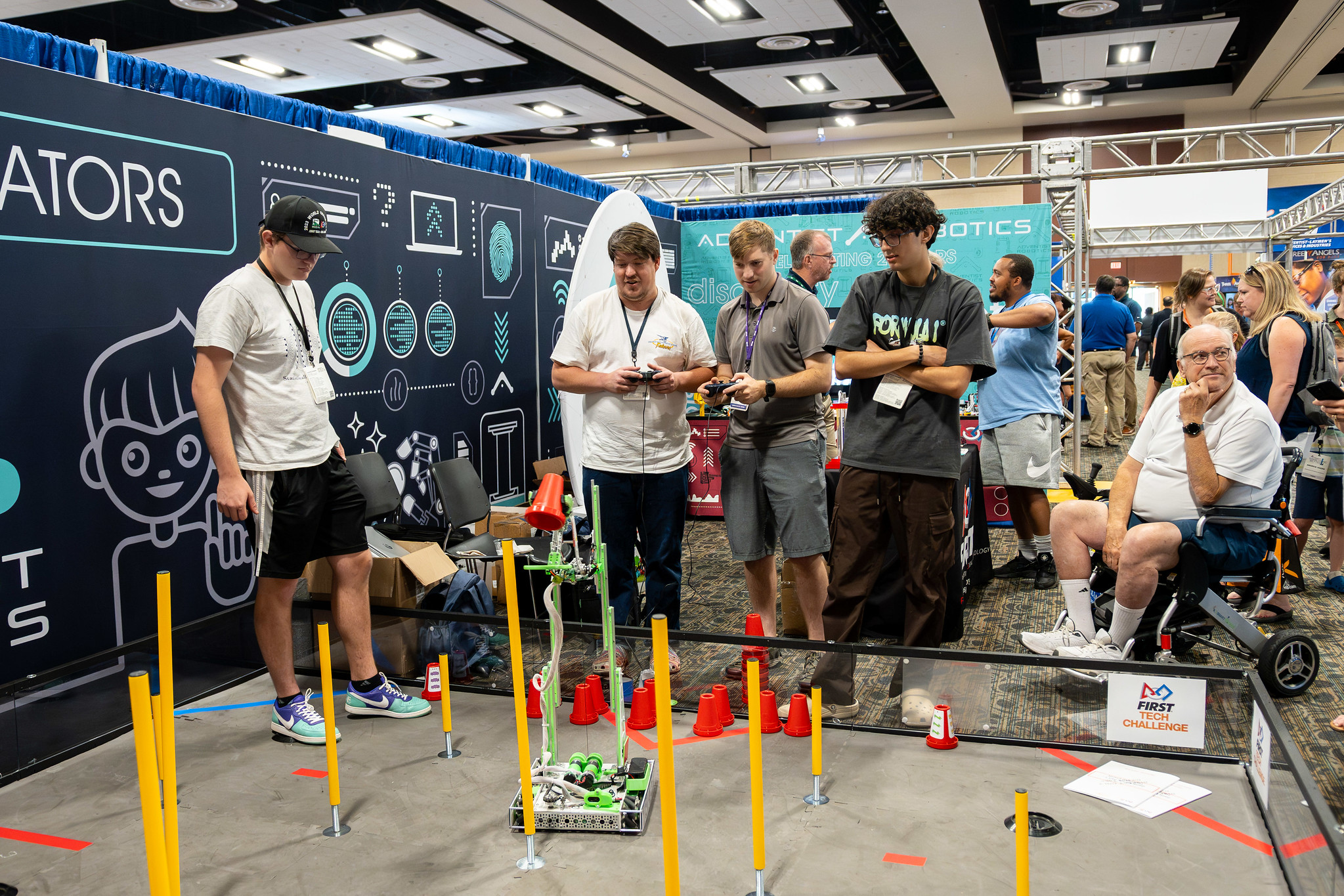 Teens try out their driving skills in the exhibit hall at the "Something Better" educators' convention.
