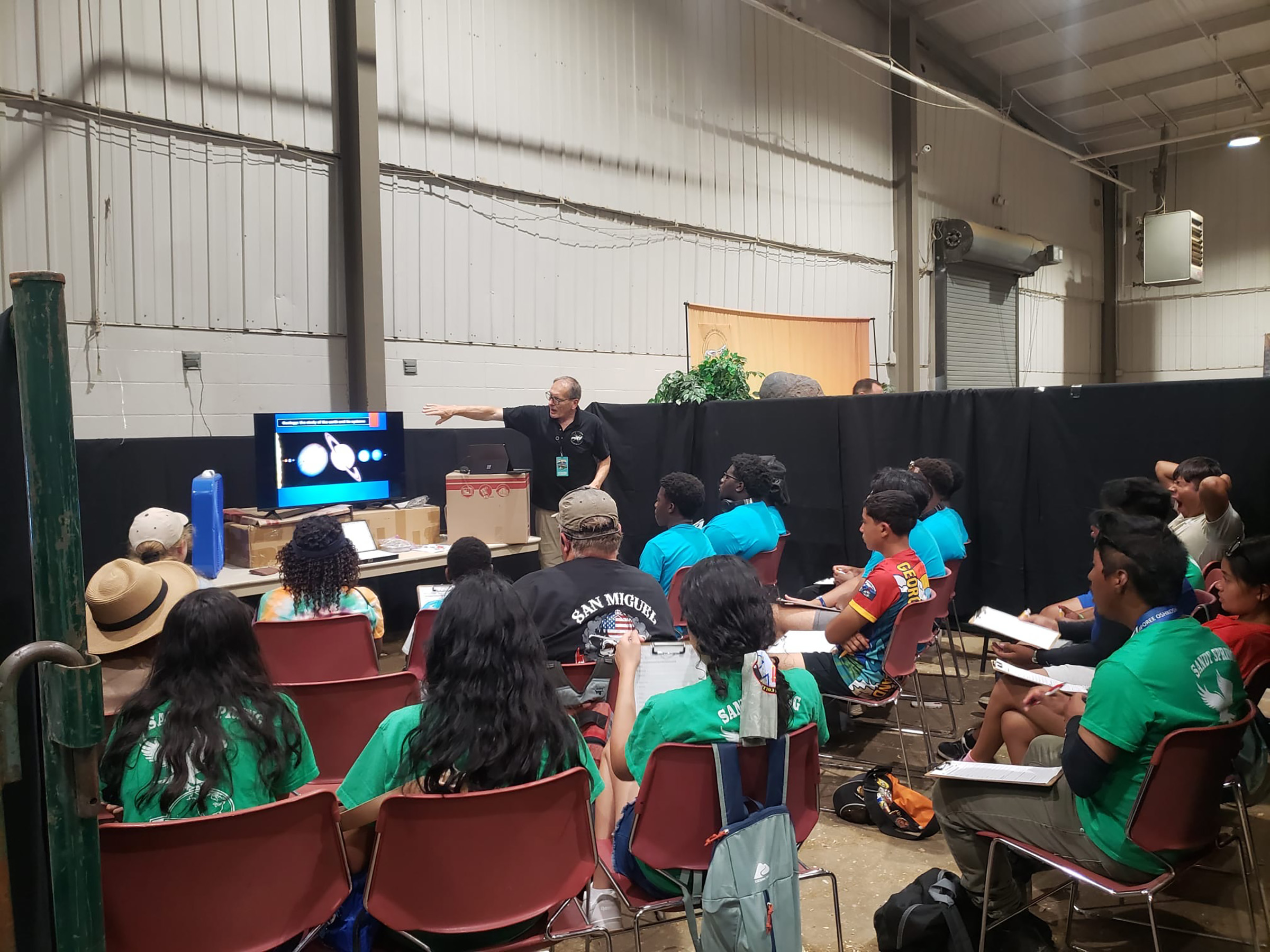 Pathfinders listen to an instructor in the GRI/NPUC booth at camporee