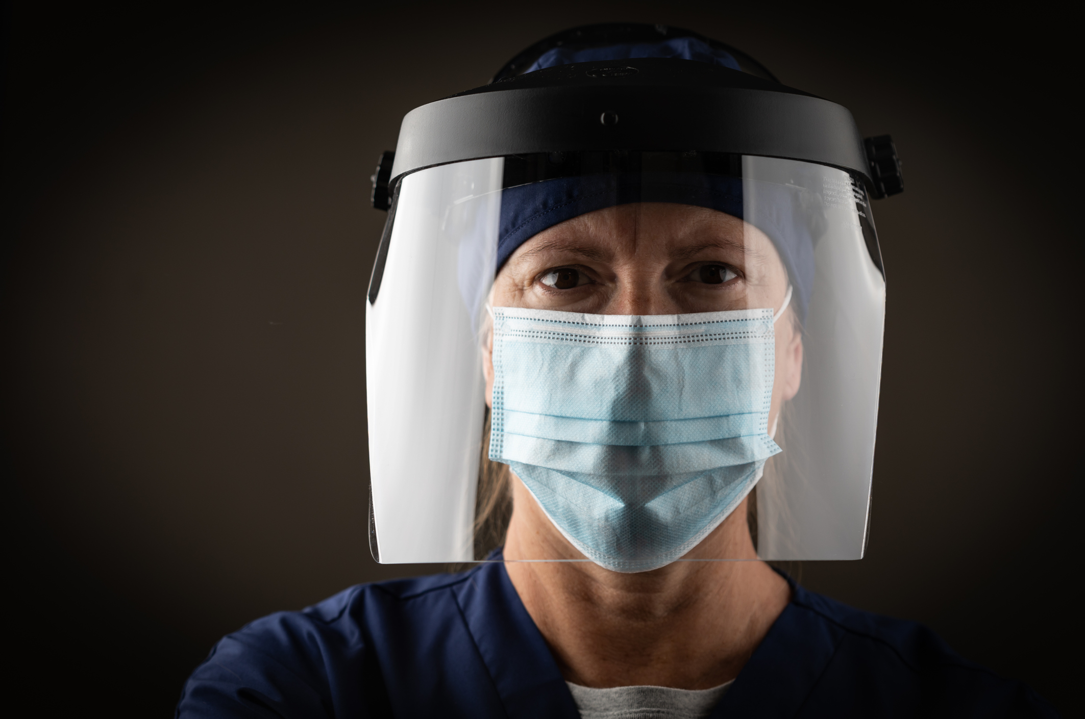 stock photo of medical worker with face shield and mask COVID-19
