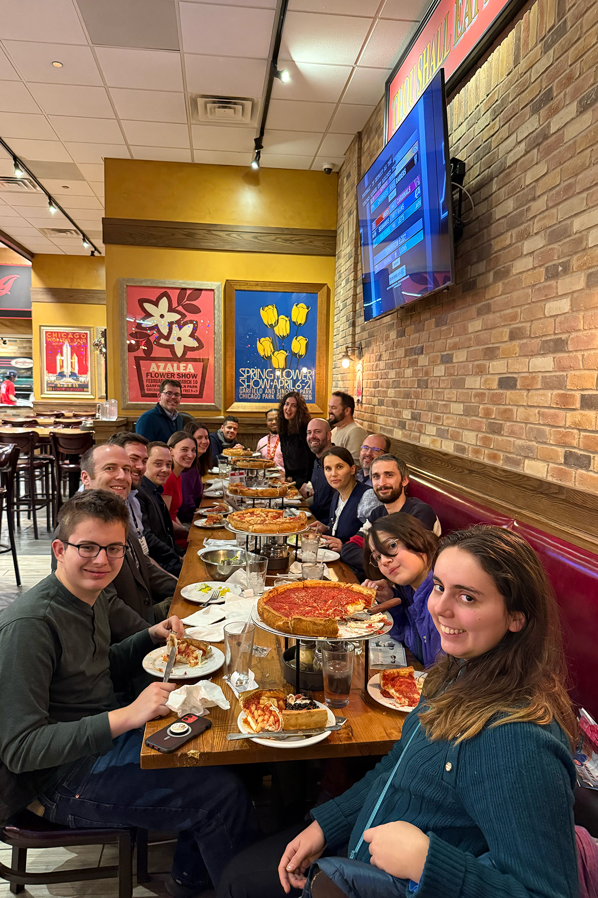 Diverse group of happy people eating pizza