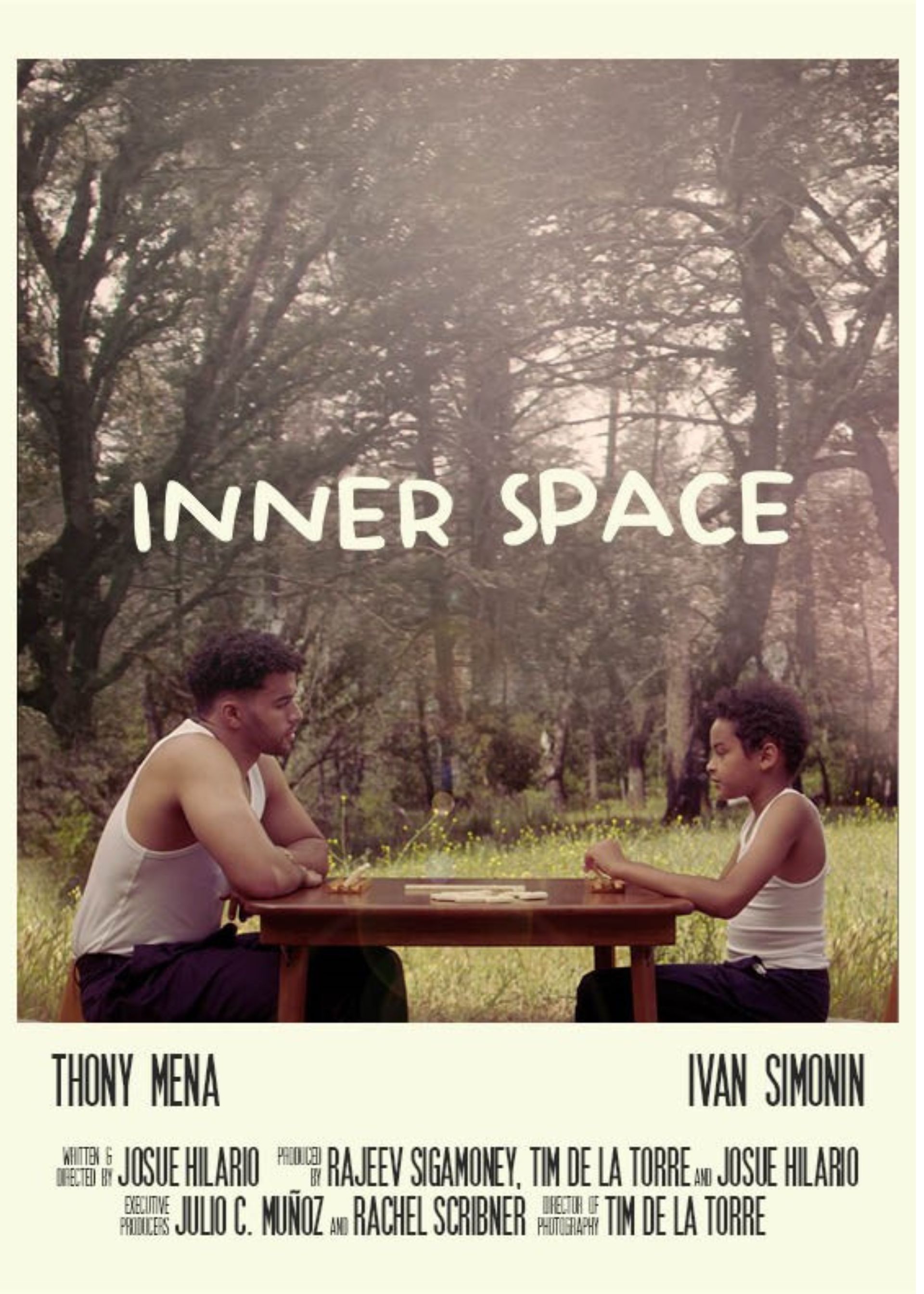 Inner Space short film promotional poster showing a young mixed race man and a young boy at a table in nature scene