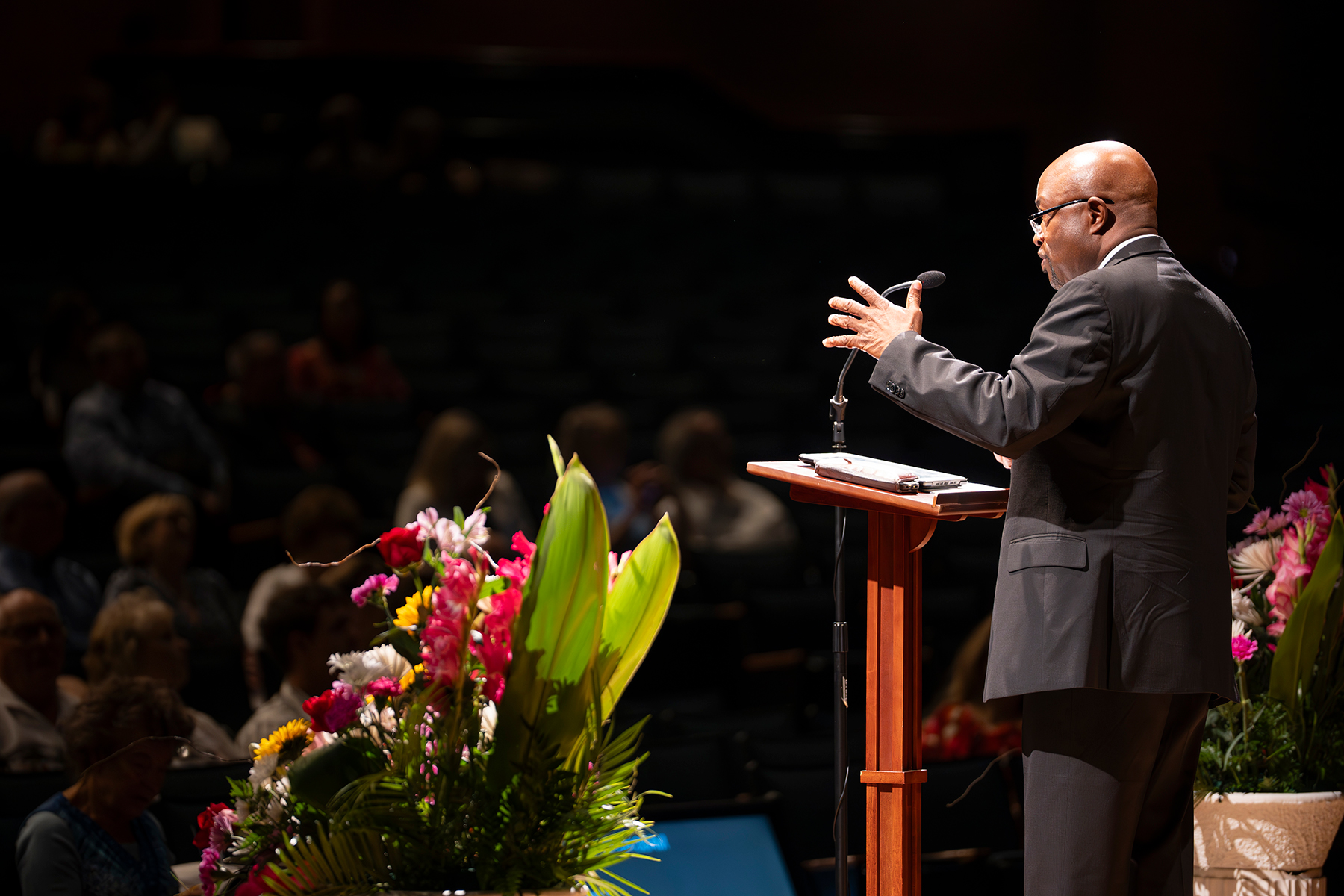 Close-up of a black man speaking on a stage