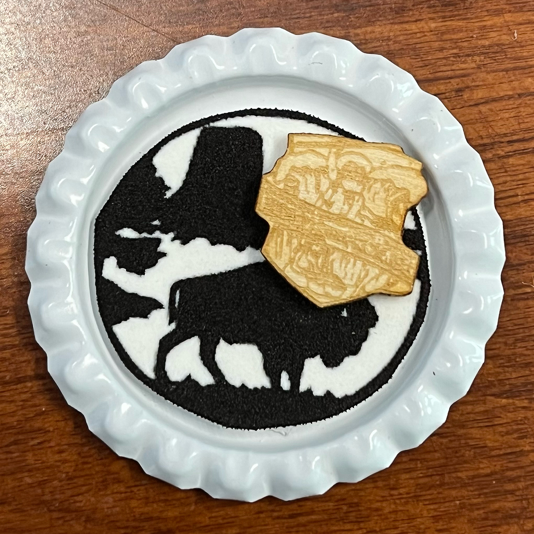 Homemade white pin with gold camporee logo and black bison